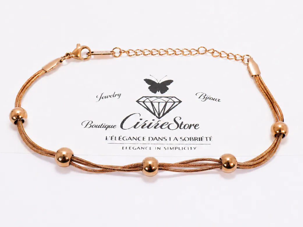Bracelet doré multirangs avec perles rondes